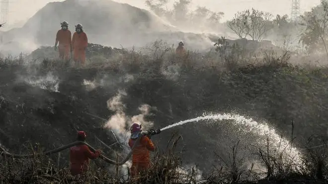 A file photo of fire service personnel spraying water to quell the smoke at Brahmapuram waste treatment plant in Kochi. A file photo of fire service personnel spraying water to quell the smoke at Brahmapuram waste treatment plant in Kochi.