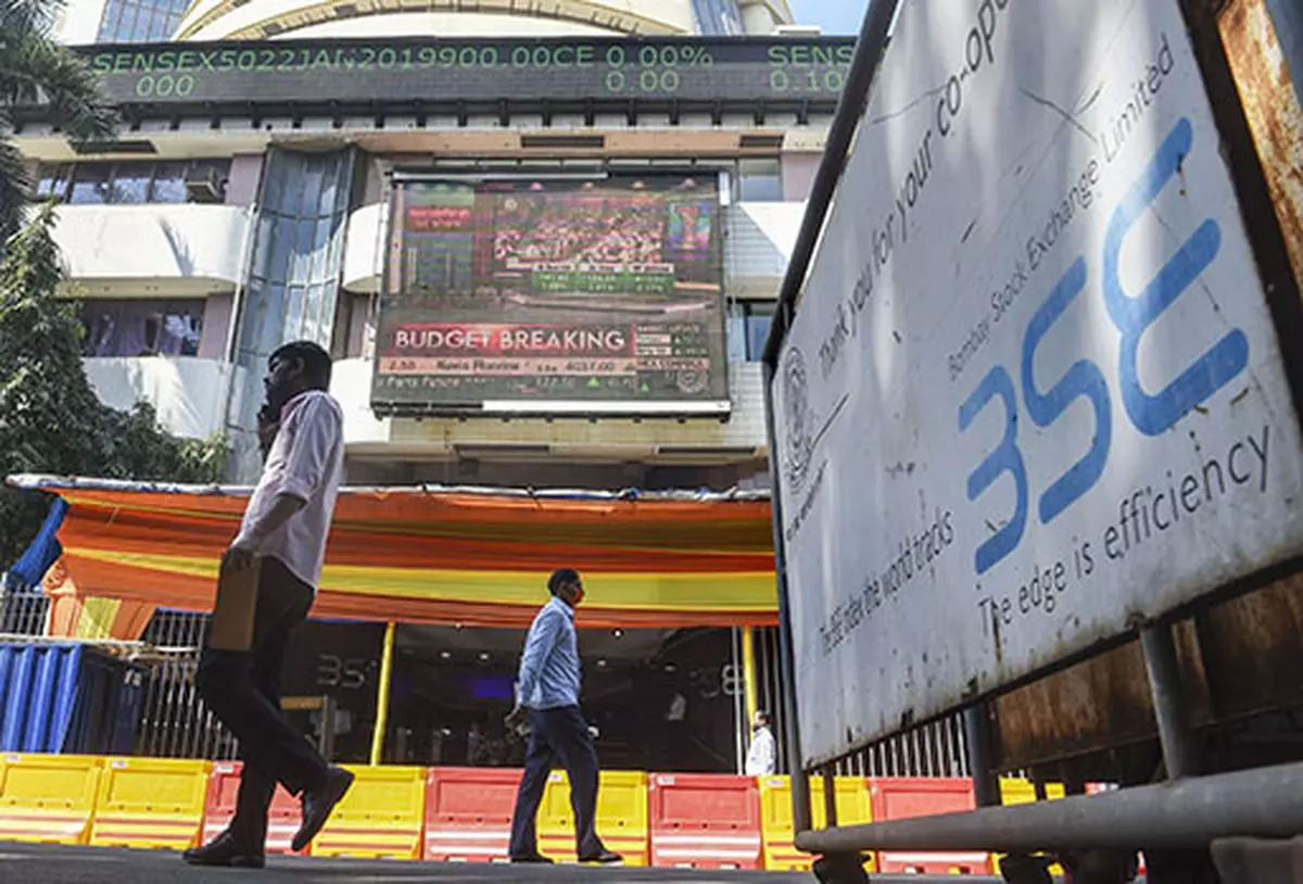 People walk past the Bombay Stock Exchange (BSE) building, in Mumbai