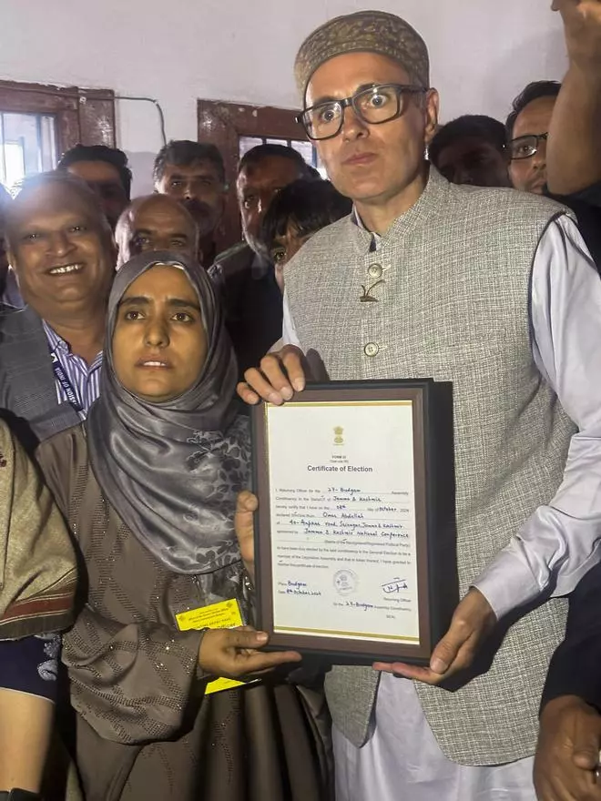   Jammu and Kashmir National Conference Vice President Omar Abdullah receives the victory certificate after winning from Budgam constituency in the JK Assembly elections, in Srinagar.  