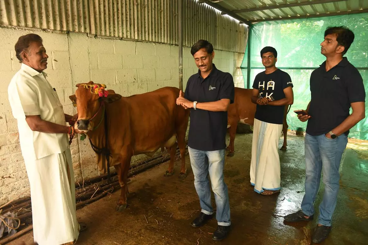 V. Nandagopal, a cattle farmer and his son , seen with K.A. Ravi, Founder and CEO, Dvara E-Dairy Solutions and the company’s Chief Technology Officer Balaji Lakshmanan, at Thandam village near Madurantakam- 120 Km from Chennai