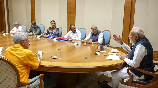 **EDS: THIRD PARTY IMAGE** In this screengrab from a video released by PMO on May 10, 2025, Prime Minister Narendra Modi, Union Defence Minister Rajnath Singh, Union External Affairs Minister S Jaishankar, National Security Advisor (NSA) Ajit Doval, Chief of the Naval Staff (CNS) Admiral Dinesh K Tripathi, Chief of the Air Staff (CAS) Air Chief Marshal AP Singh and others during a meeting at PM’s residence, after the announcement of ceasefire between India and Pakistan, in New Delhi. (PMO via PTI Photo) (PTI05_10_2025_000326B) **EDS: THIRD PARTY IMAGE** In this screengrab from a video released by PMO on May 10, 2025, Prime Minister Narendra Modi, Union Defence Minister Rajnath Singh, Union External Affairs Minister S Jaishankar, National Security Advisor (NSA) Ajit Doval, Chief of the Naval Staff (CNS) Admiral Dinesh K Tripathi, Chief of the Air Staff (CAS) Air Chief Marshal AP Singh and others during a meeting at PM’s residence, after the announcement of ceasefire between India and Pakistan, in New Delhi. (PMO via PTI Photo) (PTI05_10_2025_000326B)