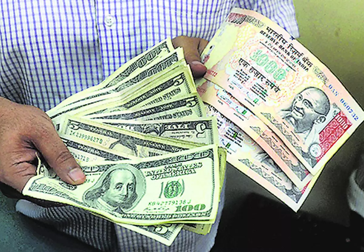 Kolkata: A money changer showing dollar & rupee notes at his foreign money exchange  shop in Kolkata on Friday. PTI 
