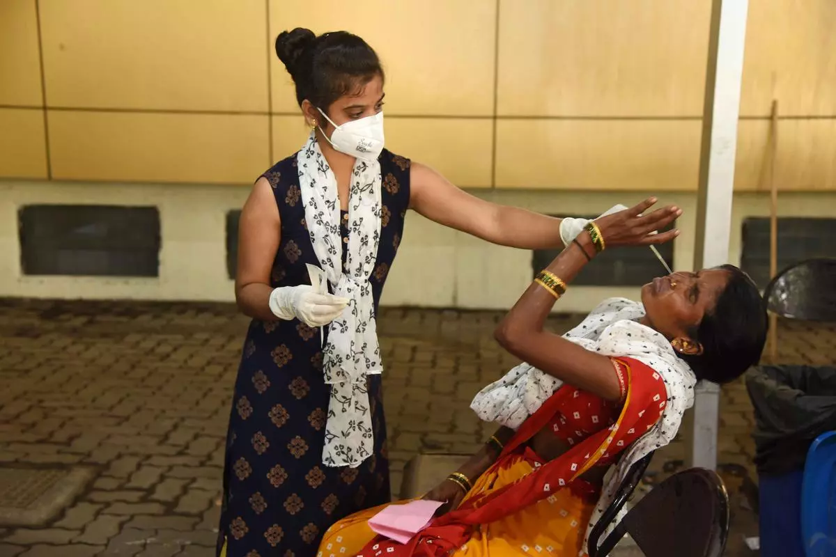Navi Mumbai: A medic collects swab sample of a woman for COVID-19 test, at Meenatai Thackeray Hospital, in Navi Mumbai, Saturday, June 25, 2022. 
