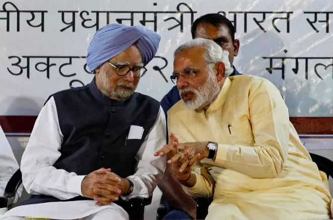 Prime Minister Manmohan Singh speaks with Gujarat’s Chief Minister Narendra Modi, the prime ministerial candidate for main opposition Bharatiya Janata Party (BJP), during the inauguration ceremony of the Sardar Vallabhbhai Patel National Museum in the western Indian city of Ahmedabad,  on October 29, 2013.