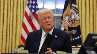 US President Donald Trump signs documents at the White House on Inauguration Day in Washington