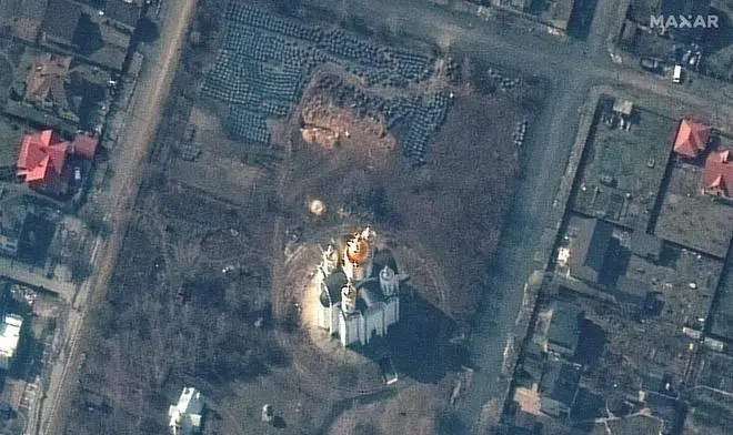 A satellite image shows the grave site with an approximately 45-foot (approximately 13,7 meters) long trench in the southwestern section of the area near the Church of St. Andrew and Pyervozvannoho All Saints, in Bucha, Ukraine, March 31, 2022 A satellite image shows the grave site with an approximately 45-foot (approximately 13,7 meters) long trench in the southwestern section of the area near the Church of St. Andrew and Pyervozvannoho All Saints, in Bucha, Ukraine, March 31, 2022
