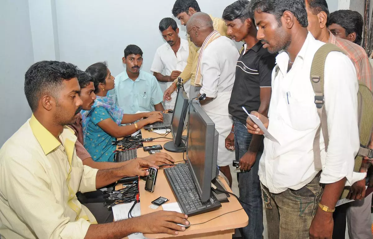 People in an outlet to get International Mobile Equipment Identity (IMEI) number for their mobile handsets, in Tiruchi.
Photo: M. Moorthy
