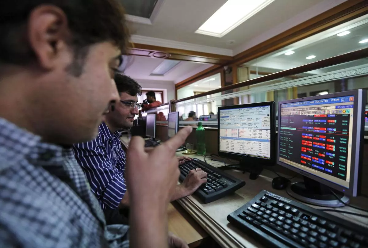 Brokers trade at their computer terminals at a stock brokerage firm in Mumbai 