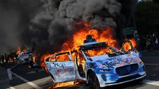 Waymo cars burn during a protest against federal immigration sweeps in downtown Los Angeles, California, U.S. June 8, 2025. 