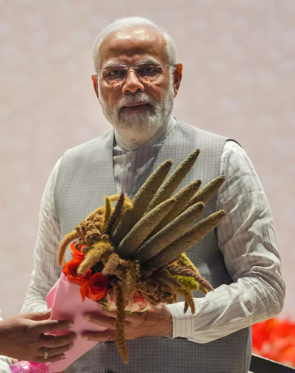 Prime Minister Narendra Modi receives a bouquet of millets during the inauguration of the 2-day ‘Global Millets (Shree Anna) Conference in  New Delhi, Saturday, March 18, 2023. 