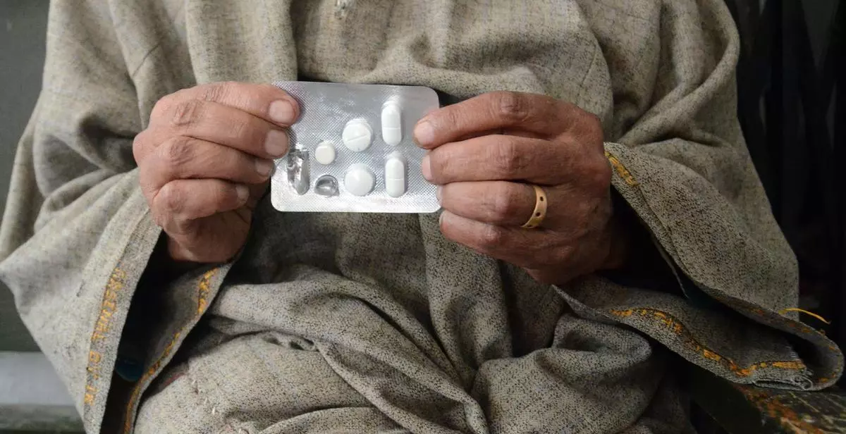 A Kashmiri Tuberculosis patient shows his anti-TB medicines which he takes daily at Kashmir’s lone chest diseases hospital in Srinagar