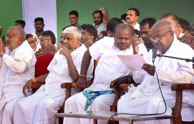 Former Prime Minister HD Devegowda (right) with his sons HD Kumaraswamy and HD Revanna