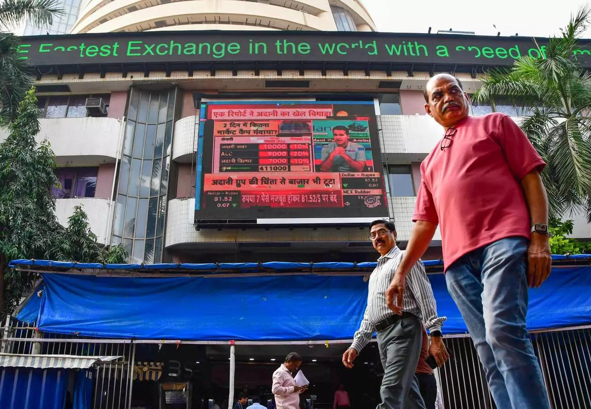 Pedestrians walk past the Bombay Stock Exchange (BSE) 