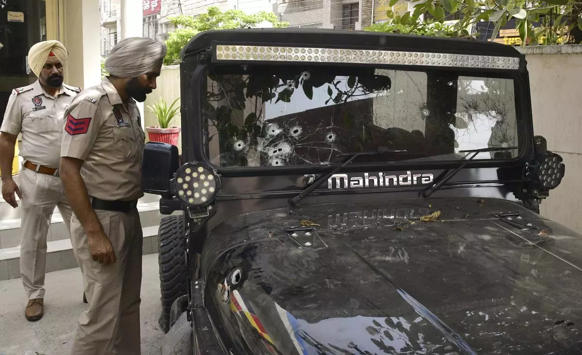 File picture of policemen examining bullet marks on the vehicle in which singer Sidhu Moosewala was gunned down, 