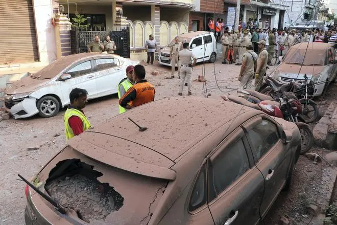 Security personnel and civilians gather near vehicles damaged due to an attack from Pakistan, in Jammu, Saturday, May 10, 2025. Security personnel and civilians gather near vehicles damaged due to an attack from Pakistan, in Jammu, Saturday, May 10, 2025.
