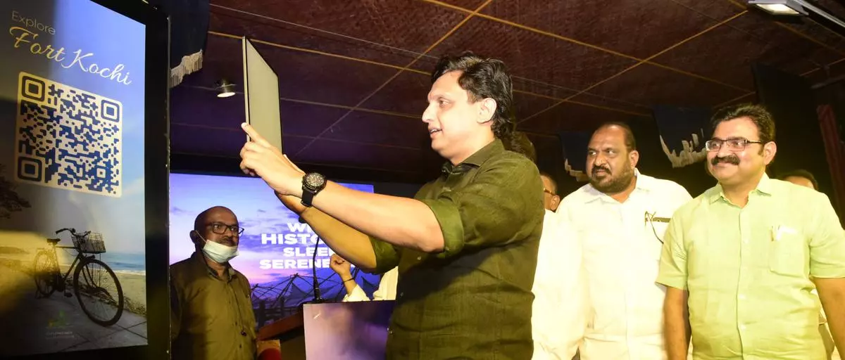 Kerala’s Tourism Minister P.A. Mohamed Riyas inaugurates a virtual travel guide by scanning the tool that provides key information about travel destinations, at Fort Kochi. Also seen are Fort Kochi MLA K.J. Maxi and Kochi Mayor M. Anilkumar.
