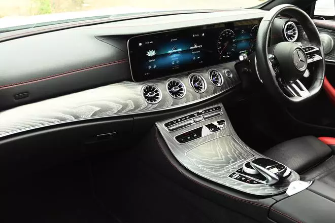 The dashboard features an E-class layout with a 12.3-inch infotainment screen and digital instrument cluster combined into one long floating display.