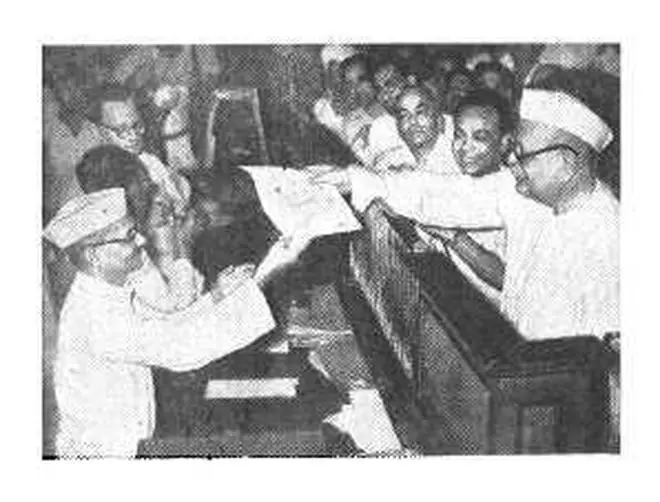 Pandit Pant, Union Home Minister inaugurates the new Postal Gift Coupon Scheme to popularise small savings in New Delhi on July 1, purchasing the first coupon from Mr. Lal Bahadur
Shastri, Union Minister for Transport at the counter. Pandit Pant, Union Home Minister inaugurates the new Postal Gift Coupon Scheme to popularise small savings in New Delhi on July 1, purchasing the first coupon from Mr. Lal Bahadur
Shastri, Union Minister for Transport at the counter.