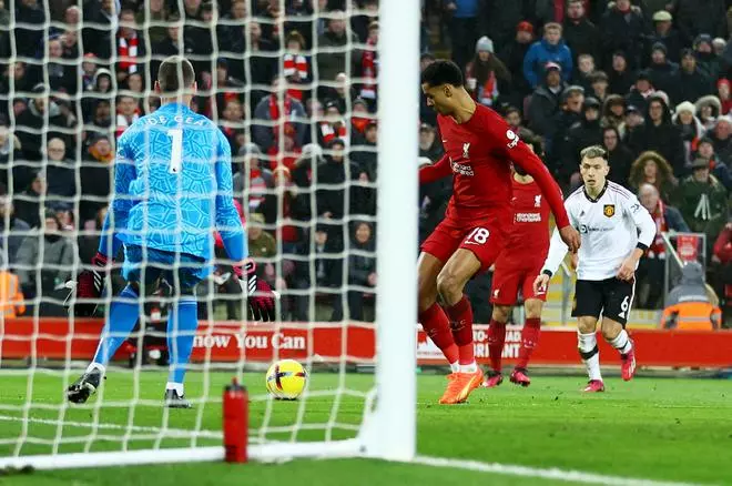 Cody Gakpo of Liverpool beats Manchester United's David de Gea to score the third goal