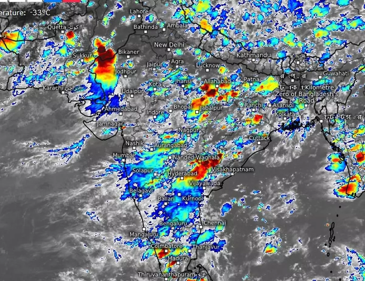 Satellite pictures on Tuesday evening showed monsoon clouds spreading out over parts of South and adjoining Peninsular India even Rajasthan in North-West India waited for heavy showers along its western flanks.