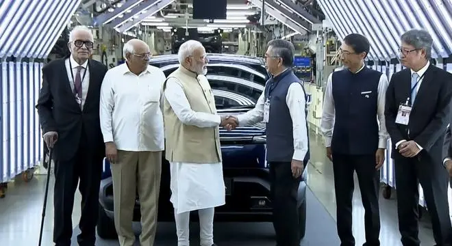 Prime Minister Narendra Modi with Gujarat Chief Minister Bhupendra Patel and others during a flagging off ceremony of Maruti Suzuki’s first electric vehicle e-Vitara from Hansalpur manufacturing facility, Gujarat