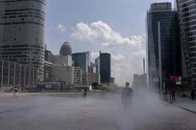 Olympic spectators cool off in water mist sprays in the La Defense business district in Paris. Climate change is increasing the intensity and frequency of summer heat waves, triggering more extreme weather events from floods to wildfires. Olympic spectators cool off in water mist sprays in the La Defense business district in Paris. Climate change is increasing the intensity and frequency of summer heat waves, triggering more extreme weather events from floods to wildfires.