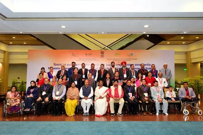President Droupadi Murmu and Union MoS for Social Justice & Empowerment Ramdas Athawale pose for a group photograph with awardees during the presentation of the National Awards for Empowerment of Persons with Disabilities in New Delhi