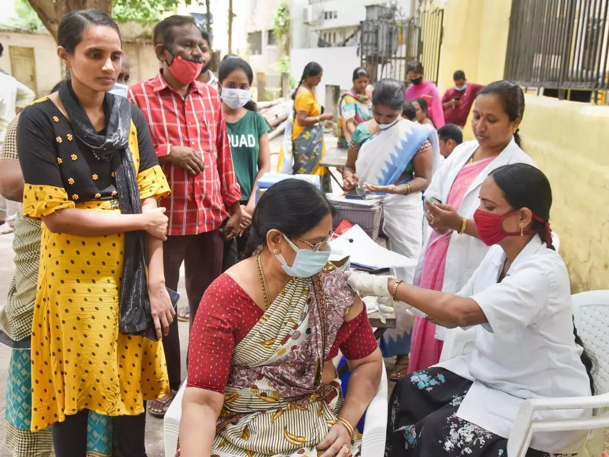 A medic administers booster shot of Covid-19 vaccine to a woman in Hyderabad, Friday, July 15, 2022. (PTI Photo)