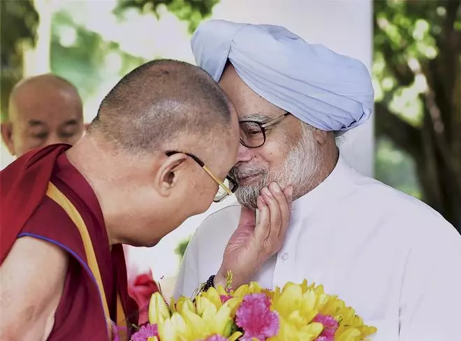 In this file image from Saturday, September 22, 2014, Tibetan spiritual leader Dalai Lama gestures during a meeting with former Prime Minister Manmohan Singh in New Delhi on Monday. 