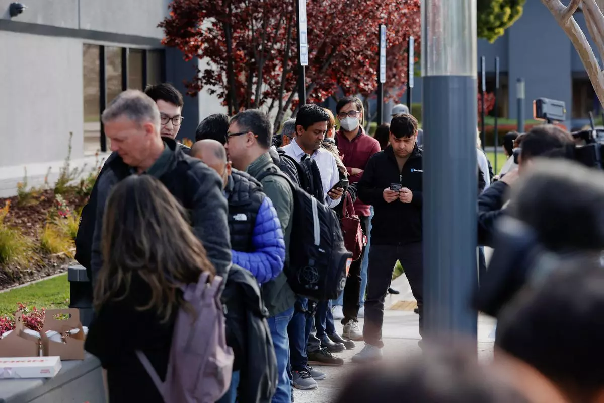 Customers line up outside of the Silicon Valley Bank headquarters, waiting to speak with representatives, in Santa Clara, California, U.S., March 13, 2023. 