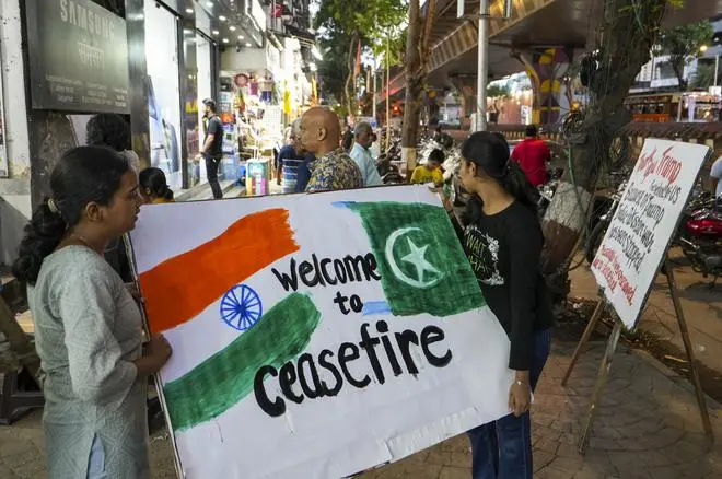 Mumbai: Students of the Gurukul School of Art carry a painting to put on display, after the announcement of ceasefire between India and Pakistan, in Mumbai, Saturday, May 10, 2025. 
