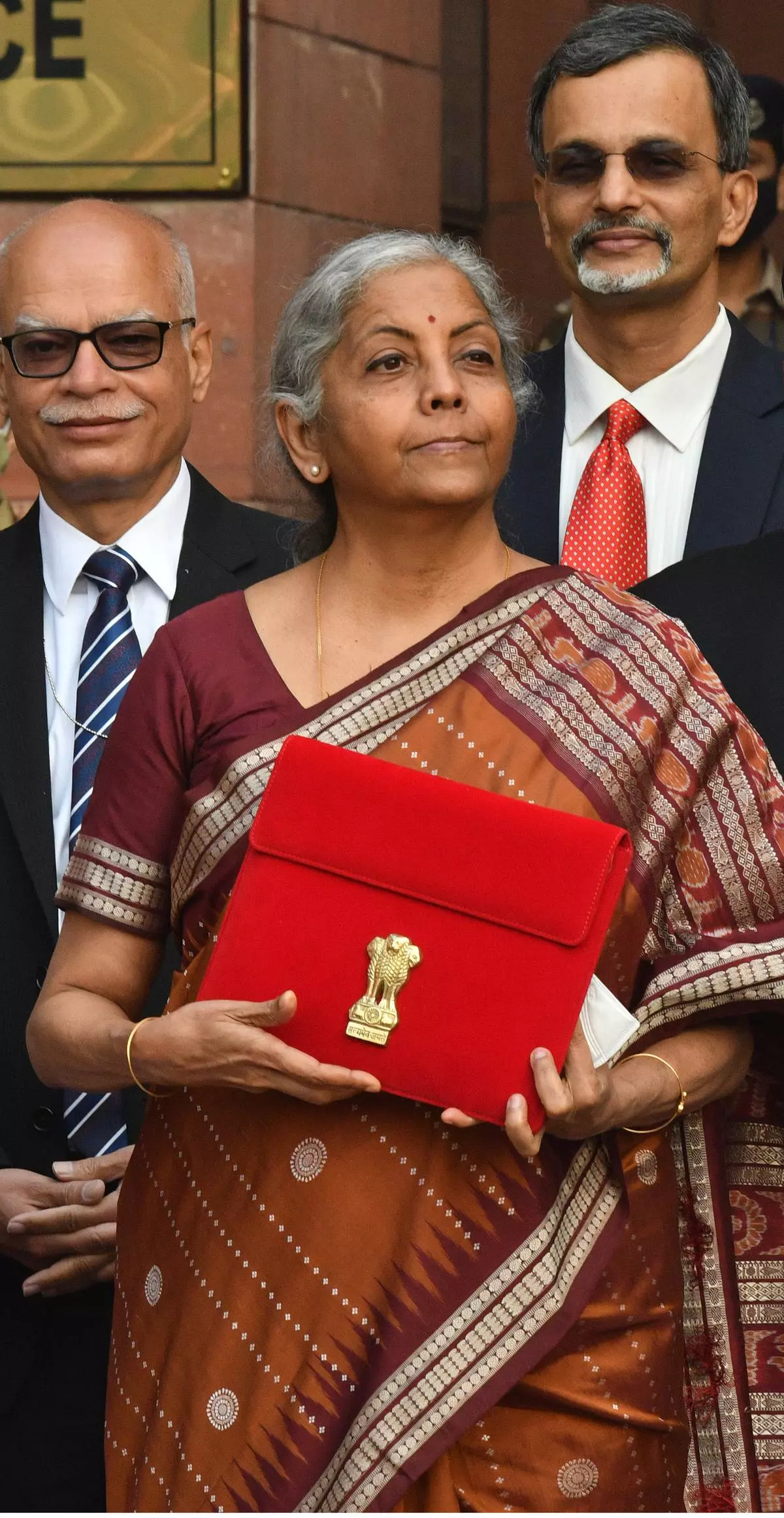 Finance Minister, Nirmala Sitharaman holds a folder-case containing the Union Budget 2022-23 as she poses for a group photograph with MoS Finance and officials of the Finance Ministry, at North Block, in New Delhi