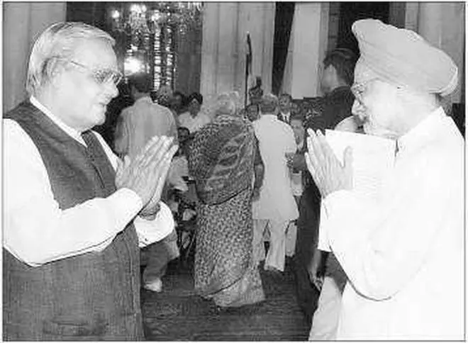 The outgoing Prime Minister, Mr A.B. Vajpayee, congratulating the new Prime Minister, Dr Manmohan Singh, at the Rashtrapati Bhavan on Saturday.