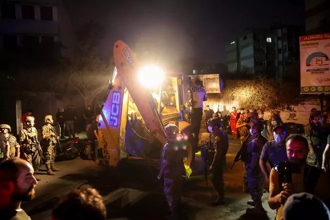 Members of the military gather after an Israeli strike, amid ongoing cross-border hostilities between Hezbollah and Israeli forces, in Beirut’s southern suburbs, Lebanon September 27, 2024. 