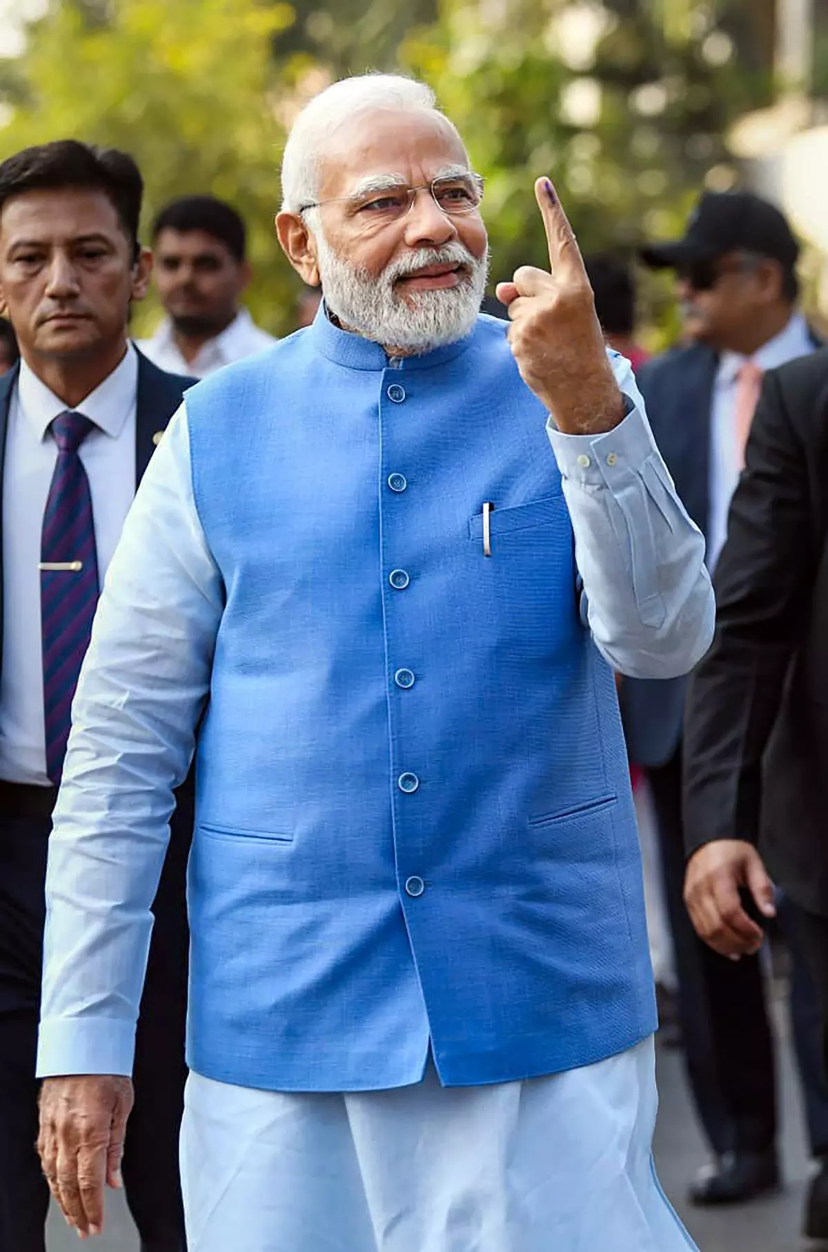 Prime Minister Narendra Modi shows his finger marked with indelible ink after casting his vote at a polling booth during the second and final phase of Gujarat Assembly elections, at Ahmedabad, Monday, December 5, 2022. 
