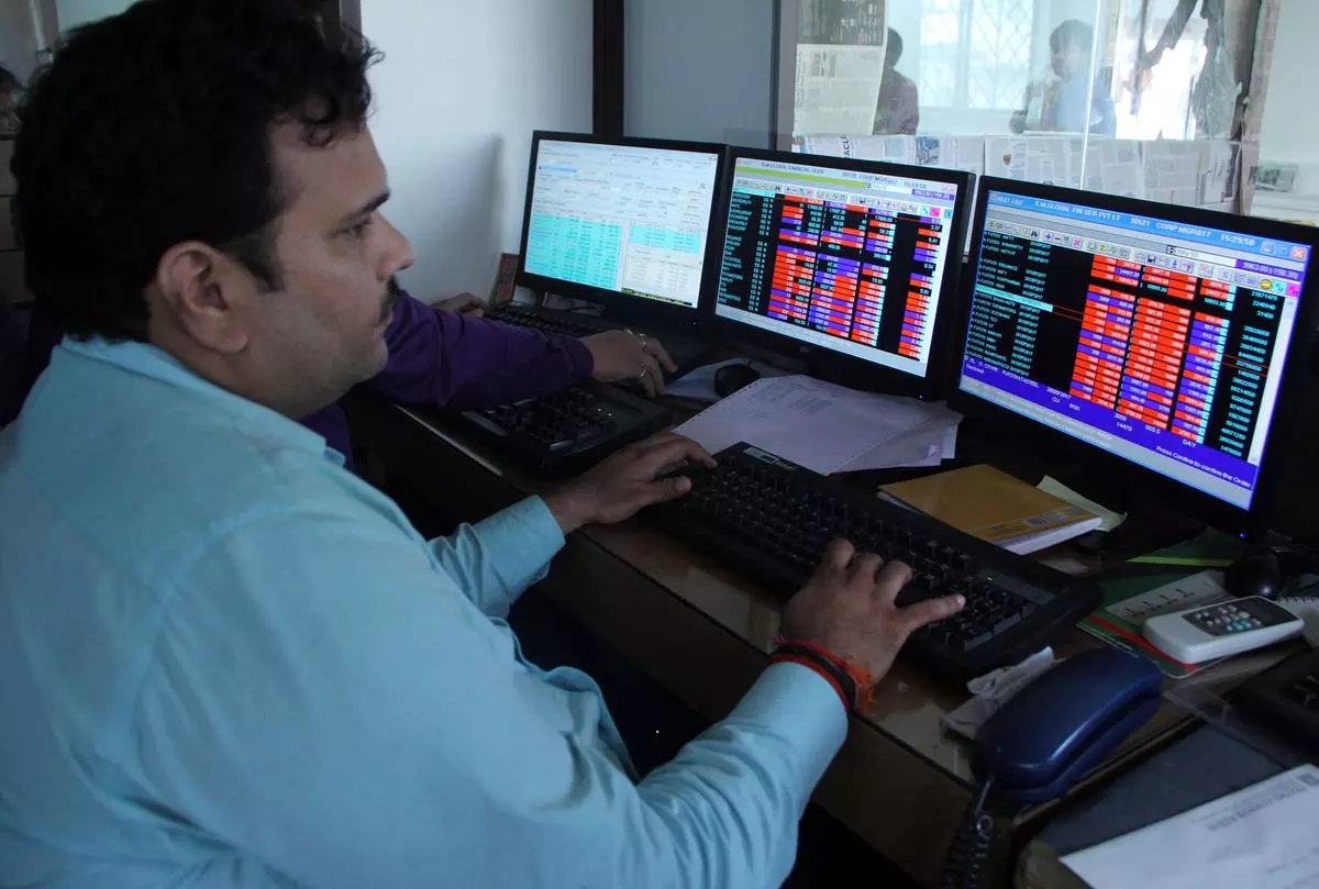 Brokers trade on their computer terminals at a stock brokerage firm as the Sensexrose 465 points in Mumbai on Monday August 8, 2022.