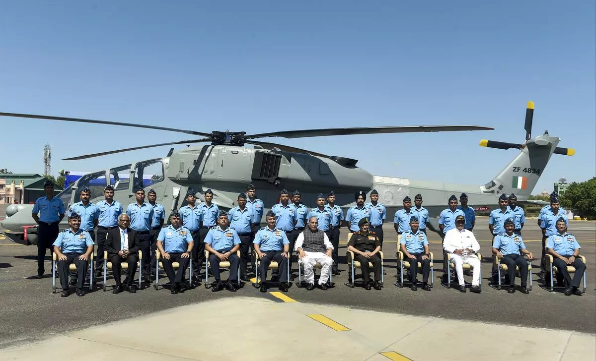 Defence Minister Rajnath Singh flanked by Chief of Defence Staff General Anil Chauhan (fifth from right) and Chief of Air Staff Air Chief Marshal VR Chaudhari (fifth from left) during the induction ceremony of the Light Combat Helicopter in Jodhpur on Monday