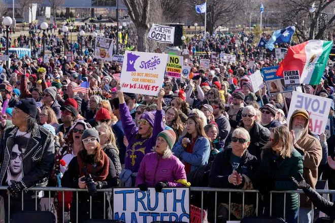 Demonstrators hold placards as they congregate at the Minnesota State Capitol during a 'No Kings' protest against U.S. President Donald Trump's administration policies, in St. Paul, Minnesota, U.S., March 28, 2026. REUTERS/Erica Dischino