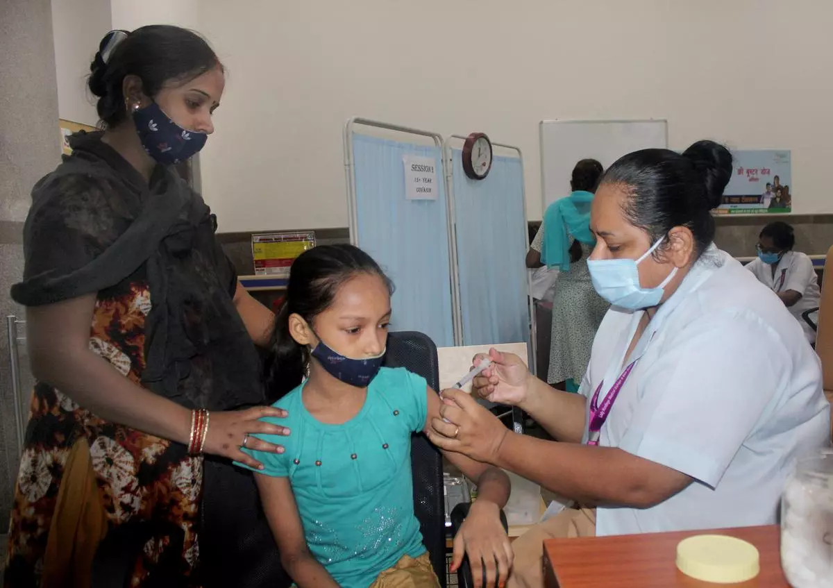 A healthworker administers a vaccine to a beneficiary at Lady Hardinge hospital in New Delhi on Wednesday