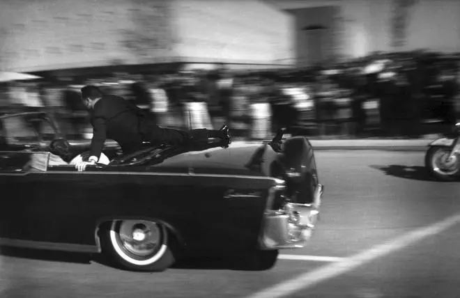 In this Nov. 22, 1963 file photo, the limousine carrying mortally wounded President John F. Kennedy races toward the hospital seconds after he was shot in Dallas.    