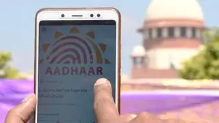 A person checks his Aadhaar deatils on his mobile phone A person checks his Aadhaar deatils on his mobile phone