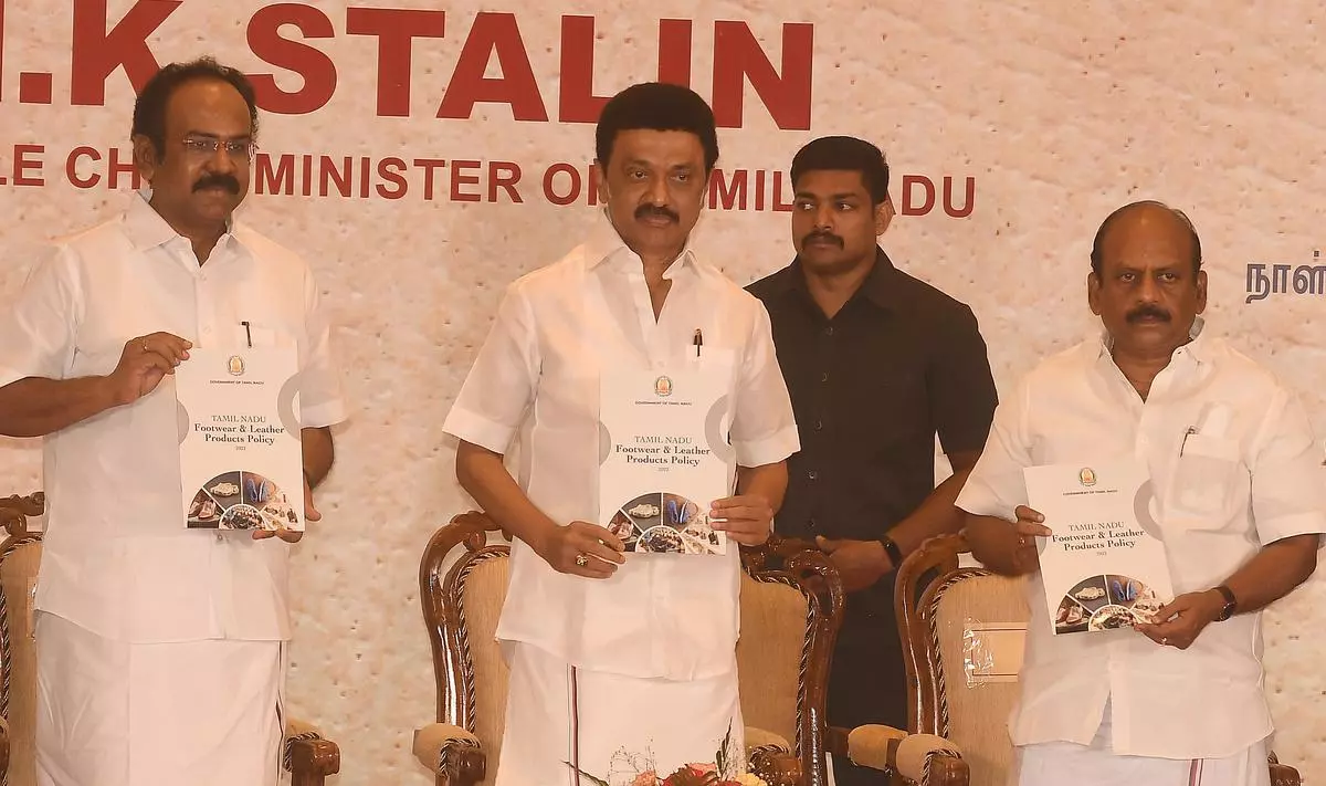 Tamil Nadu Chief Minister M.K. Stalin releasing the TN Footwear and Leather Products Policy in the presence of Industries Minister Thangam Thennarasu (left) and MSME Minister T.M. Anbarasan at the Footwear and Leather Sector Conclave in Chennai on Tuesday. 