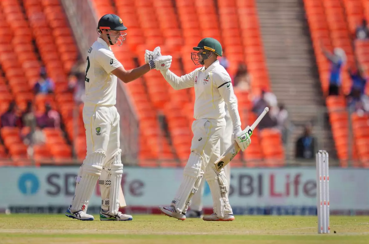 Australian batter Usman Khawaja celebrates with teammate Cameron Green after scoring 150 runs on the second day of the fourth test cricket match between India and Australia, at the Narendra Modi stadium in Ahmedabad, on Friday.