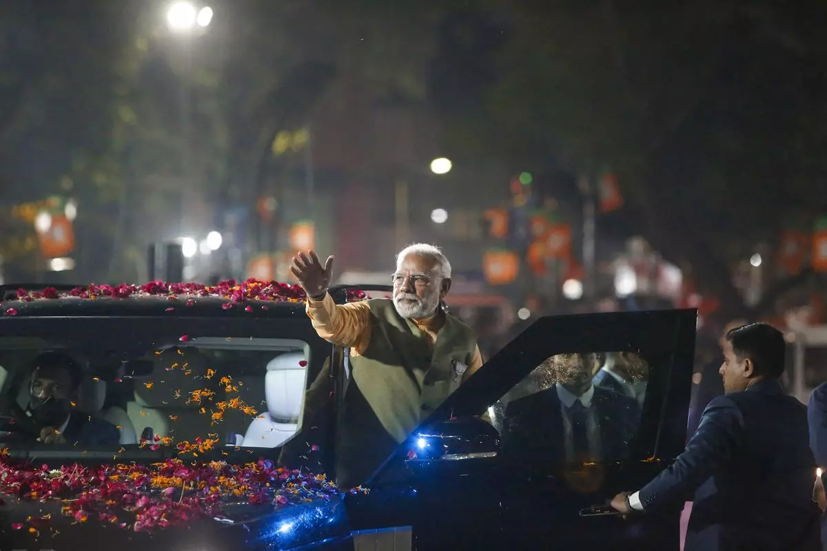 Ahmedabad: Prime Minister Narendra Modi waves at supporters during his election campaign roadshow for Gujarat Assembly polls in Ahmedabad