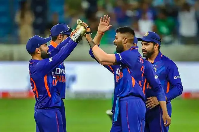 Indian bowler Hardik Pandya celebrates with teammate Dinesh Karthik after a wicket during the Asia Cup 2022 cricket match between India and Pakistan, at Dubai International Cricket Stadium, UAE. India won by 5 wickets. 