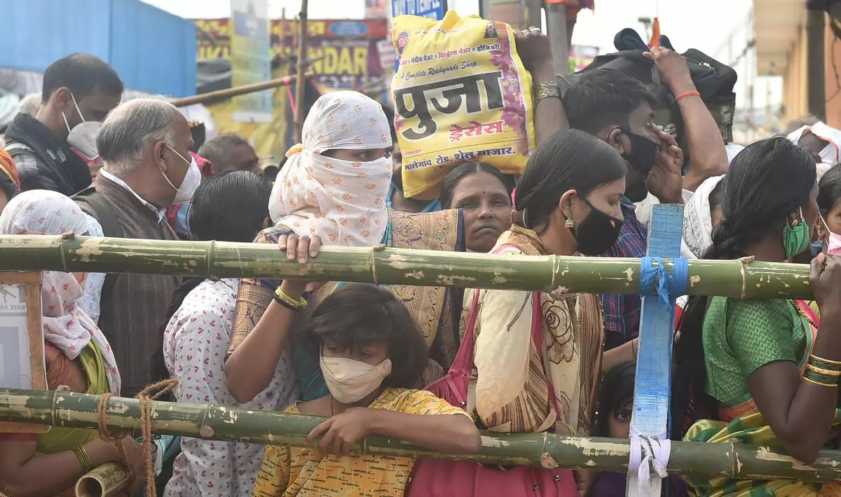 Pilgrims stand in close proximity to each other, flouting social distancing norms   during the Gangasagar Mela 2022 in South 24 Parganas district of West Bengal on Thursday. PTI 