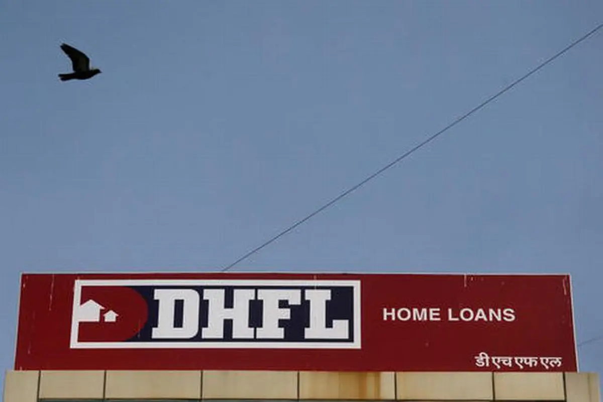 A bird flies past a signboard of Dewan Housing Finance Corporation outside its office in Mumbai 