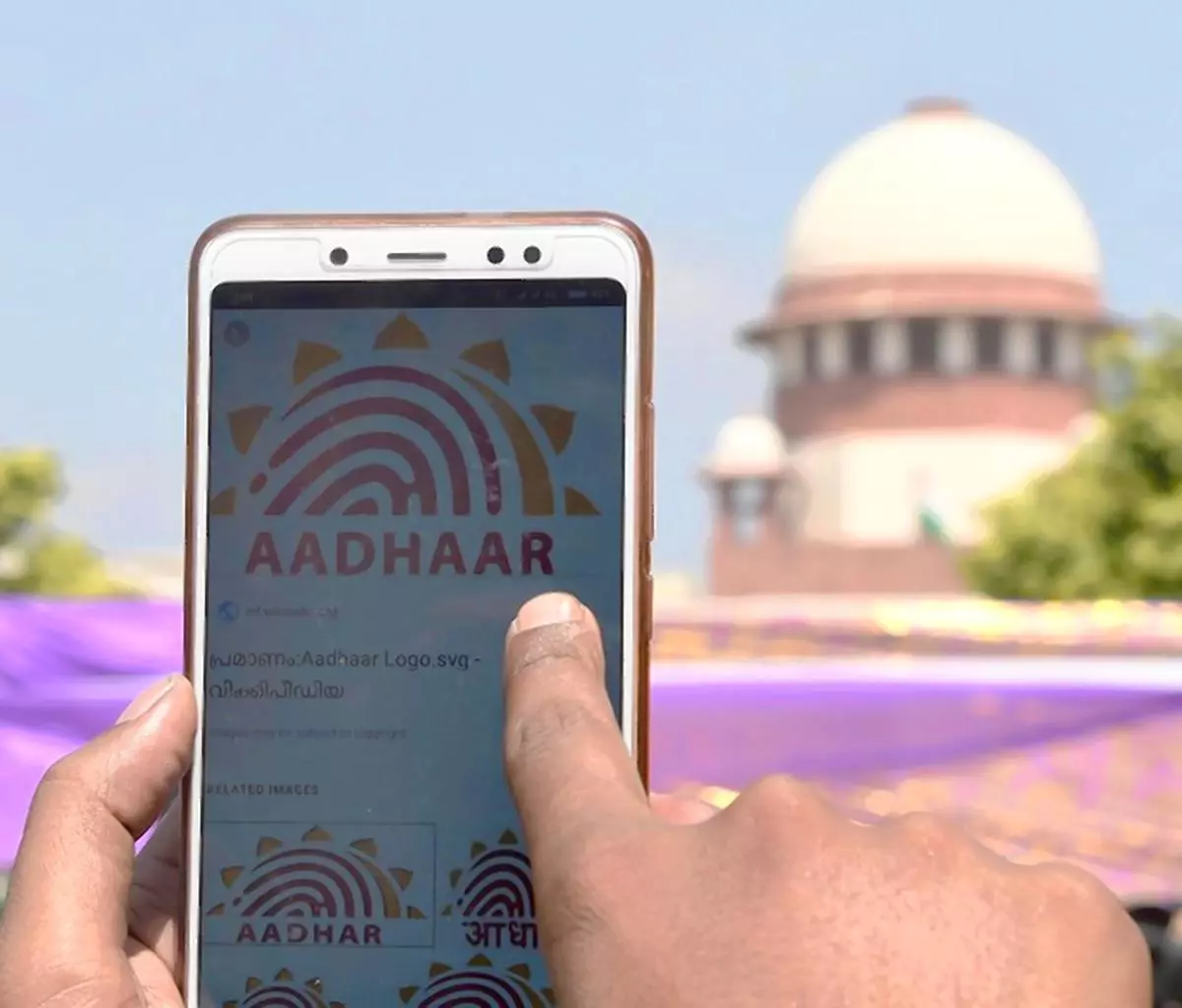 A person checks his Aadhaar deatils on his mobile phone