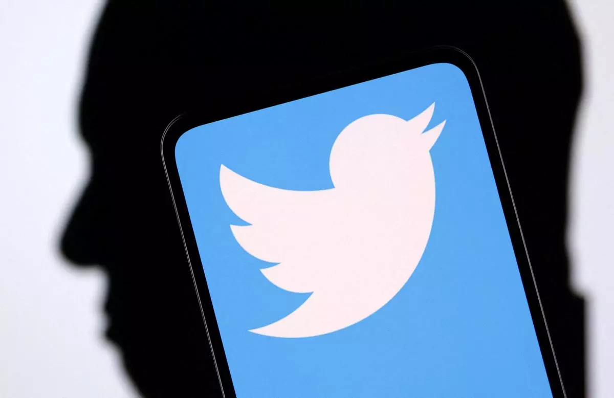 FILE PHOTO: Twitter logo and Elon Musk silhouette are seen in this illustration 