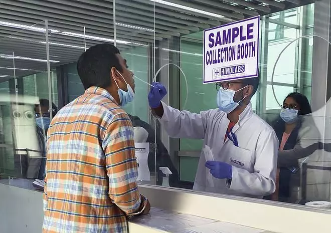 An air passenger undergoes a sample for the Covid-19 tests at the airport, in Kolkata